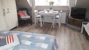 a bedroom with a bed and a table and chairs at Beachhouse Engelbert Studios in Zandvoort