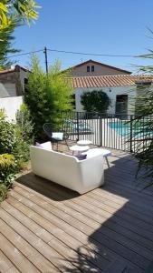 モンペリエにあるVILLA MONTPELLIERの木製のデッキの上に置かれた白いソファ