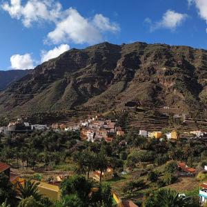 a mountain with a town and houses on it at Finca La Ladera in Valle Gran Rey