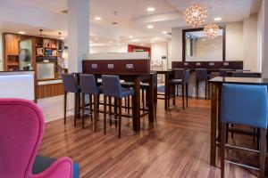 a kitchen and dining room with a table and chairs at Holiday Inn Express Leicester City, an IHG Hotel in Leicester