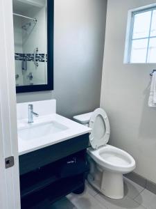 a bathroom with a sink and a toilet and a mirror at The Lexmar - Dodger Stadium Hollywood in Los Angeles