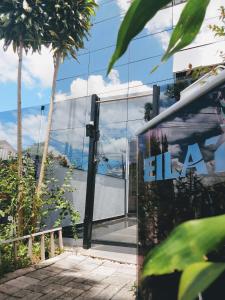 a glass building with the ala logo on it at Eilat. אילת Pousada Bacacheri in Curitiba