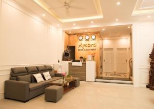 a living room with a couch and a counter at Amora Hotel & Apartment in Vung Tau