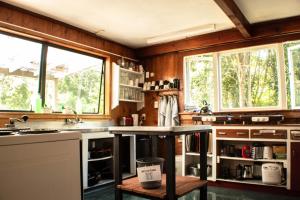 
a kitchen with a stove top oven and a window at The Barn Cabins & Camp in Marahau
