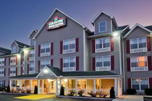 a hotel with a sign that reads cambridge inn at Country Inn & Suites by Radisson, Hiram, GA in Hiram
