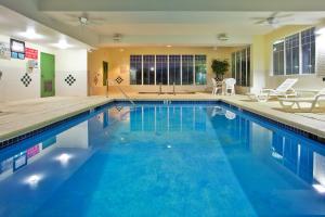 a large swimming pool with blue water at Country Inn & Suites by Radisson, Hiram, GA in Hiram