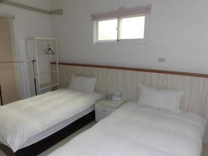 Postel nebo postele na pokoji v ubytování Shiang Ching Home Stay