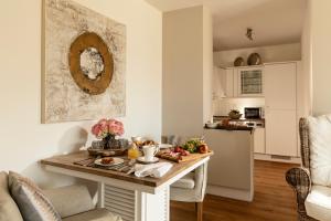 a kitchen with a table with food on it at Techts Apartmenthaus in Timmendorfer Strand