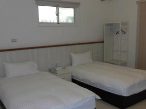 Postel nebo postele na pokoji v ubytování Shiang Ching Home Stay