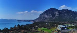 a view of a mountain and a body of water at Y Resort Jeju in Seogwipo