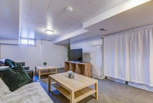 a living room with a couch and a table at Modern Townhouse with pool table by CozySuites in Alexandria