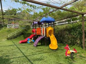 a childrens playground with a play set in the grass at 風山雅筑莊園 in Tongluo