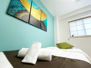 Ένα ή περισσότερα κρεβάτια σε δωμάτιο στο OUCHI HOTEL Yokogawa