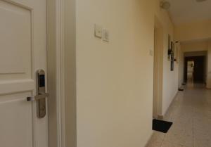 a hallway with a white door and a hallway with a hallwayngth at Sunquest Gardens Holiday Resort in Limassol