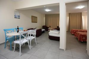 a living room with a couch and a table and chairs at Sunquest Gardens Holiday Resort in Limassol
