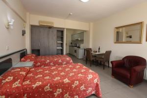 a hotel room with a bed and a chair and a table at Sunquest Gardens Holiday Resort in Limassol
