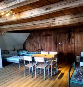 a room with a table and chairs and a bed at Penzion Ostrov u Stribra 13 in Kostelec