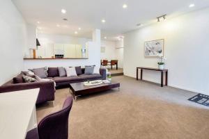 a living room with a couch and a table at Spacious 2BR Near Westfield Newmarket in Auckland