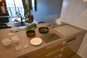 a kitchen counter with two pots and a stove at The Grand Residence Hotel Tenjin in Fukuoka