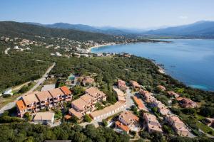 an aerial view of a resort next to a body of water at La Punta Geronimi in Porto Pollo