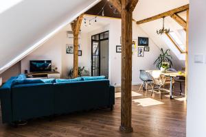 a living room with a blue couch and a table at Apartament Dobre Miejsce 2 in Ustrzyki Dolne