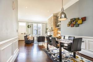 a dining room and living room with a table and chairs at Astonishing Old Town Colonial Home with parking CozySuites in Alexandria