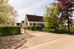 una casa blanca con techo negro en Boerderij de Zalm, en Schalkwijk