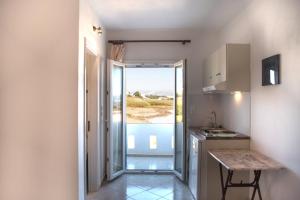 a kitchen with a view of the ocean from a room at Molos Studios in Naxos Chora