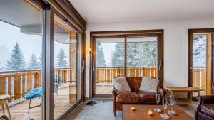 a living room with a couch and a table at Les Freinets - Apt D102 - BO Immobilier -Châtel Multipass 2026 Activités en Été en option à 4euros par jour et par personne in Châtel