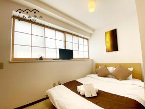 Ένα ή περισσότερα κρεβάτια σε δωμάτιο στο OUCHI HOTEL Yokogawa