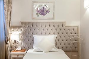 Postel nebo postele na pokoji v ubytování Hotel Aurelia
