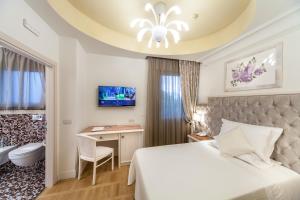 Postel nebo postele na pokoji v ubytování Hotel Aurelia