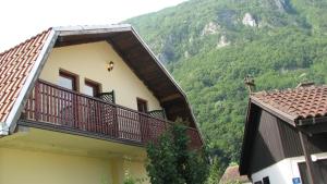 a building with a balcony with a mountain in the background at Perucac Apartment in Perućac