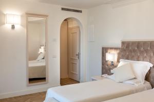 Postel nebo postele na pokoji v ubytování Hotel Aurelia