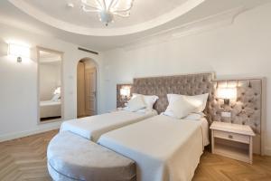 Postel nebo postele na pokoji v ubytování Hotel Aurelia