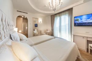 Postel nebo postele na pokoji v ubytování Hotel Aurelia