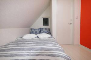 Postel nebo postele na pokoji v ubytování アンドステイ高砂2丁目