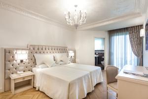 Postel nebo postele na pokoji v ubytování Hotel Aurelia