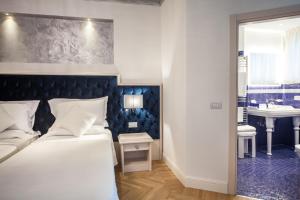 Postel nebo postele na pokoji v ubytování Hotel Aurelia