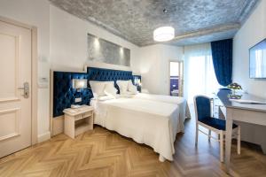 Postel nebo postele na pokoji v ubytování Hotel Aurelia