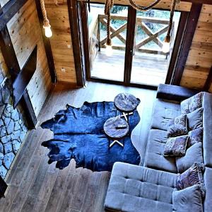 a living room with a couch and a table at Apartman Dunja -Ski skola in Kopaonik