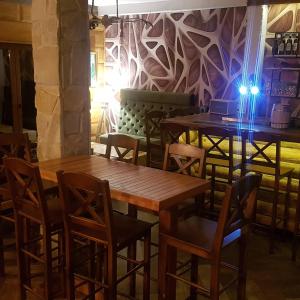 a group of tables and chairs in a restaurant at Apartman Dunja -Ski skola in Kopaonik