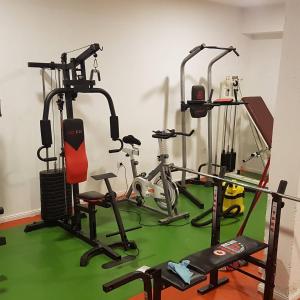 a gym with three exercise bikes in a room at Apartman Dunja -Ski skola in Kopaonik +10 photos