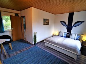 a bedroom with a large bed with a butterfly headboard at Pension Jägerrast in Boek