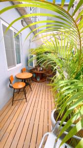 un porche con una mesa, sillas y plantas en Funky Song, en Tainan