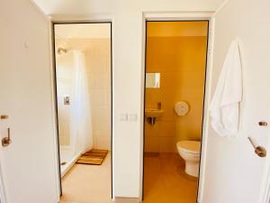 a bathroom with a toilet and a sink at Oasis Backpackers Hostel Sintra Surf in Sintra +87 photos