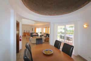 a dining room and living room with a table and chairs at Vila Girasol, 171 - Clever Details in Vilamoura
