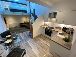 a kitchen and living room in a small apartment at King Street Serviced Apartments in Lancaster
