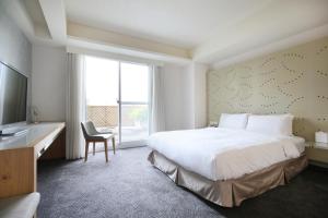 Rúm í herbergi á Dandy Hotel-Daan Park Branch