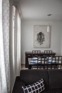 a living room with a couch and a table at MonteSanto Del Rey in Belo Horizonte